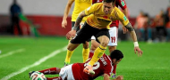 Zhang Linpeng of Guangzhou Evergrande jumps over Ahmed Kenawi of Al Ahly, image courtesy of Reuters