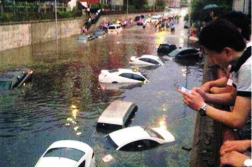 beijing flooding bridge underpass cars rain sewage infrastructure